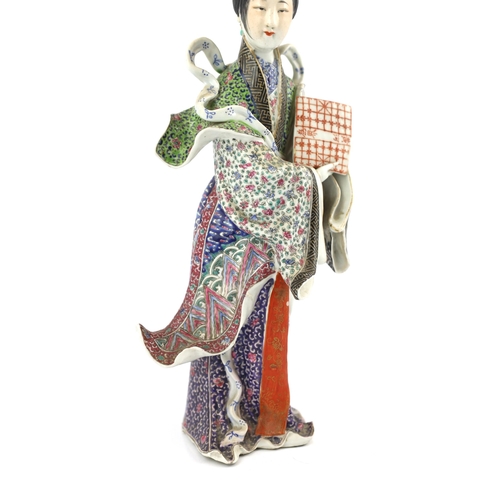 506 - A Chinese enamelled porcelain figure of a lady, Republic period, the standing figure of a lady weari... 