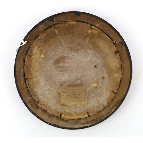 518 - An Arts and Crafts brass and copper roundel, in the manner of Archibald Knox, monogrammed CA, ebony ... 