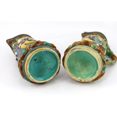 523 - A pair of Victorian Minton majolica Tower jugs, 33cm high