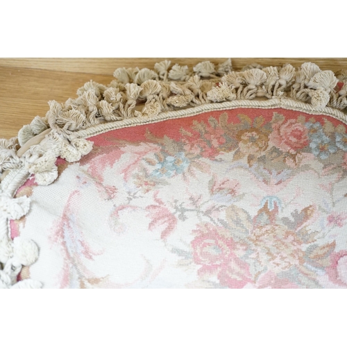 536 - Four 20th century oval floral needlework cushion covers, design with sprays of roses in pastel colou... 