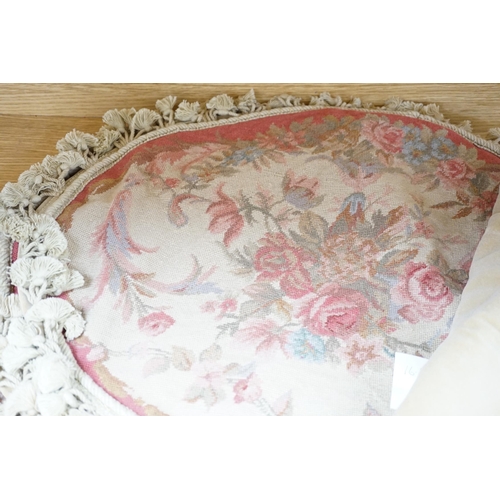 536 - Four 20th century oval floral needlework cushion covers, design with sprays of roses in pastel colou... 