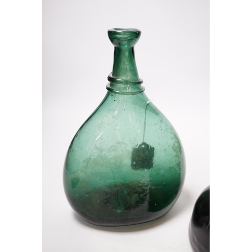 538 - An 18th century black glass mallet form bottle with neck rim, 17cm and an 18th century Persian green... 