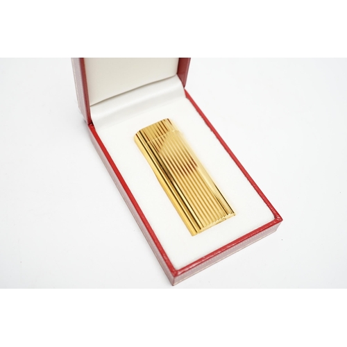 570 - A Cartier gold plated lighter, with box and certificate.