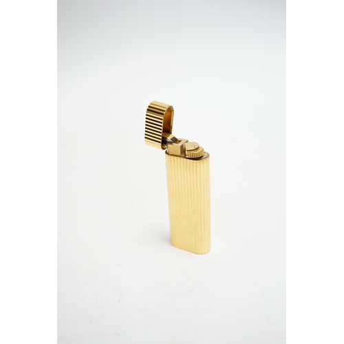 570 - A Cartier gold plated lighter, with box and certificate.