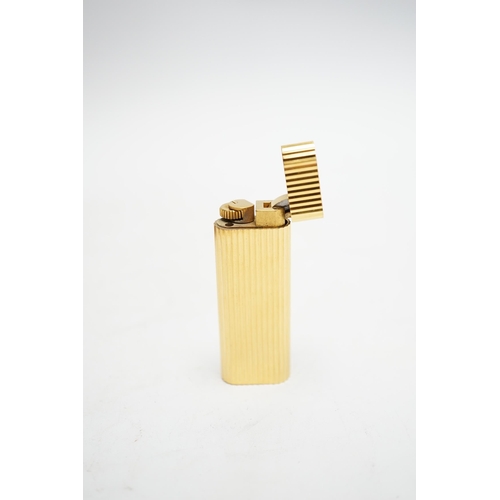 570 - A Cartier gold plated lighter, with box and certificate.