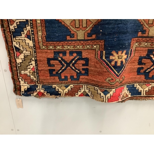 61 - An antique Caucasian blue ground rug, 160 x 115cm