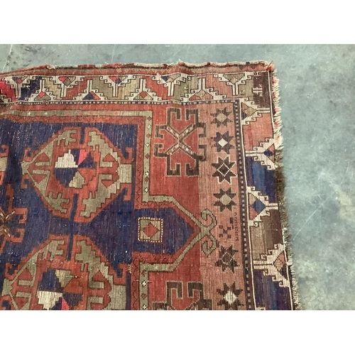 61 - An antique Caucasian blue ground rug, 160 x 115cm