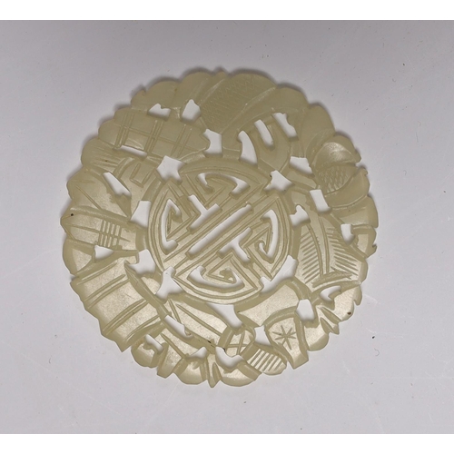 626 - A Chinese carved disc, possibly jade, 5.5cm in diameter