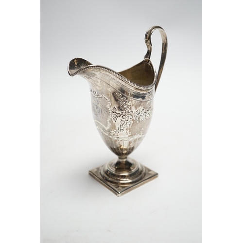 828 - A George III engraved silver helmet shaped cream jug, on square foot, Soloman Hougham, London, 1796,... 