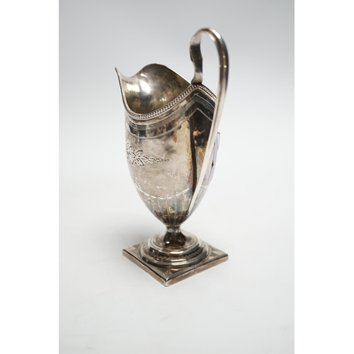 828 - A George III engraved silver helmet shaped cream jug, on square foot, Soloman Hougham, London, 1796,... 