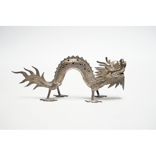 844 - A Chinese white metal toothpick holder, modelled as a free standing model of a dragon, 12.4cm.... 