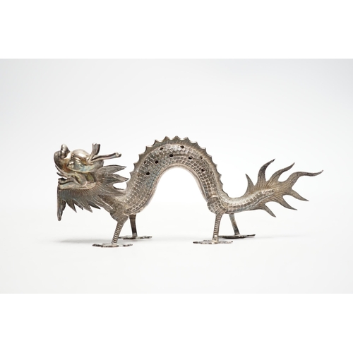 844 - A Chinese white metal toothpick holder, modelled as a free standing model of a dragon, 12.4cm.... 