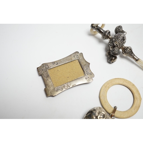 858 - An Edwardian silver and mother of pearl child's rattle, 11cm, together with a miniature white metal ... 