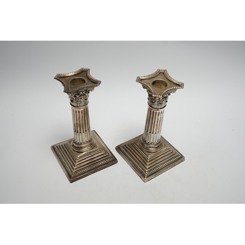 875 - A pair of George V silver mounted Corinthian column dwarf candlesticks, London, 1911, 15.7cm, weight... 