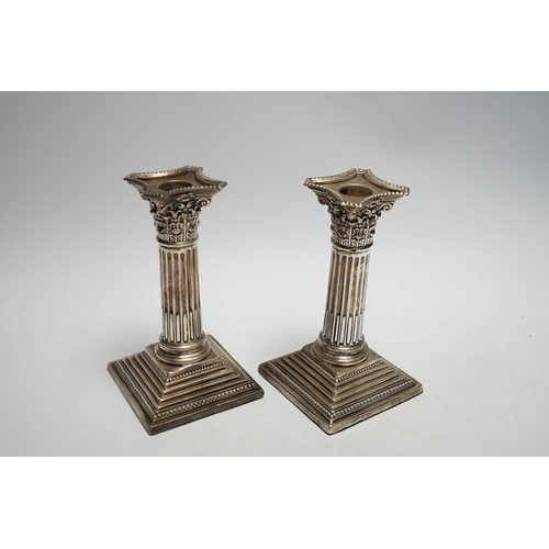 875 - A pair of George V silver mounted Corinthian column dwarf candlesticks, London, 1911, 15.7cm, weight... 