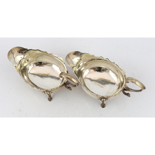 881 - A pair of late George II silver small sauce boats, by Robert Albin Cox, with cut rims and flying scr... 