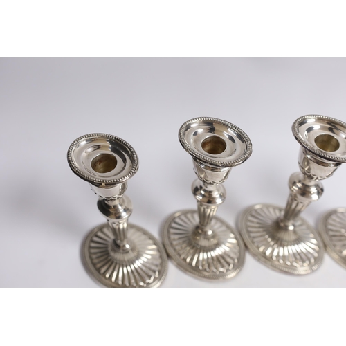 884 - A set of four Elizabeth II silver candlesticks, with fluted stems and bases, C.J. Vander Ltd, London... 