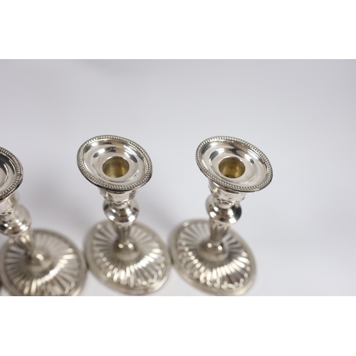 884 - A set of four Elizabeth II silver candlesticks, with fluted stems and bases, C.J. Vander Ltd, London... 