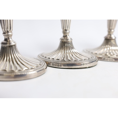 884 - A set of four Elizabeth II silver candlesticks, with fluted stems and bases, C.J. Vander Ltd, London... 