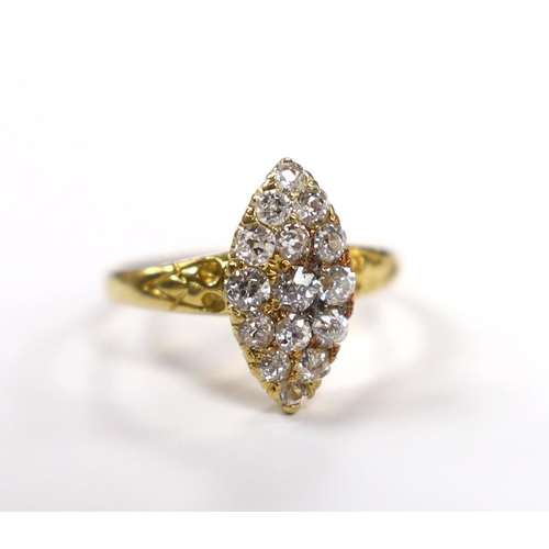 903 - An early 20th century yellow metal and old round cut diamond cluster set marquise shaped ring, size ... 