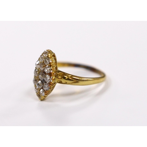 903 - An early 20th century yellow metal and old round cut diamond cluster set marquise shaped ring, size ... 