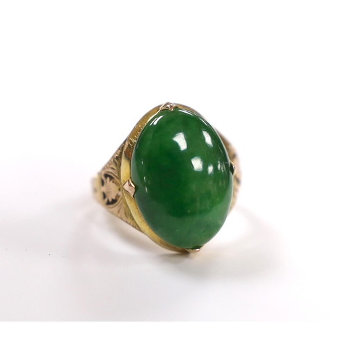 916 - A Chinese 14k yellow metal and oval cabochon jade set ring, size I, gross weight 5.4 grams.