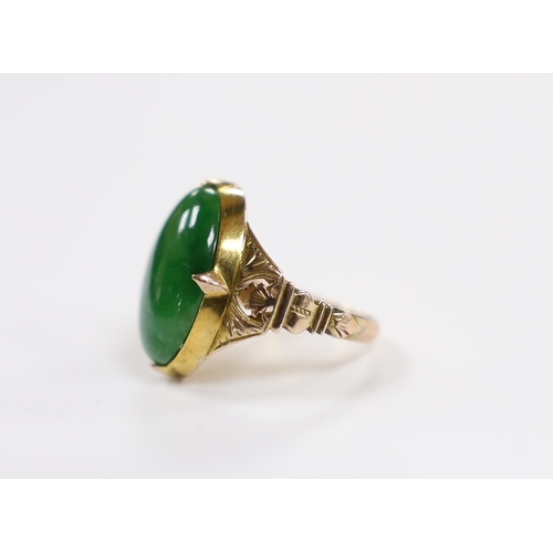 916 - A Chinese 14k yellow metal and oval cabochon jade set ring, size I, gross weight 5.4 grams.