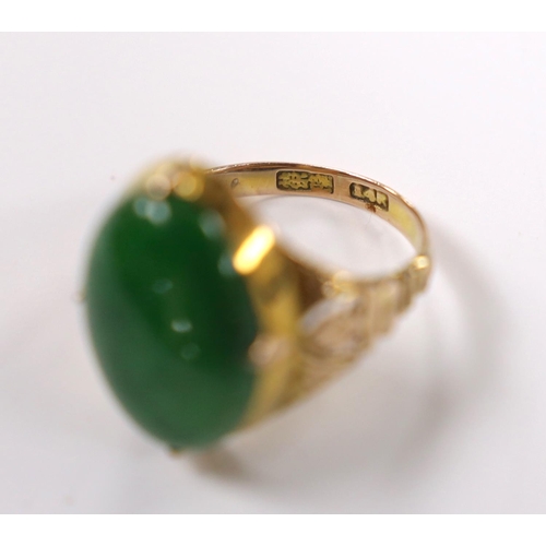 916 - A Chinese 14k yellow metal and oval cabochon jade set ring, size I, gross weight 5.4 grams.