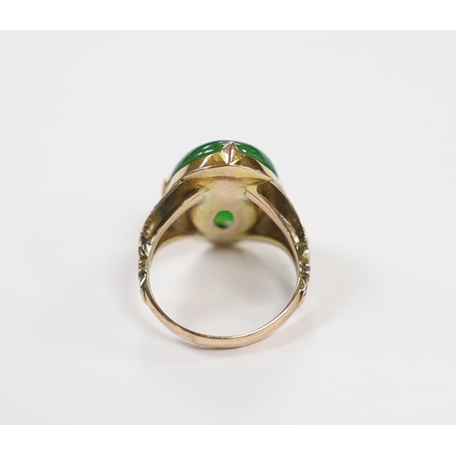 916 - A Chinese 14k yellow metal and oval cabochon jade set ring, size I, gross weight 5.4 grams.