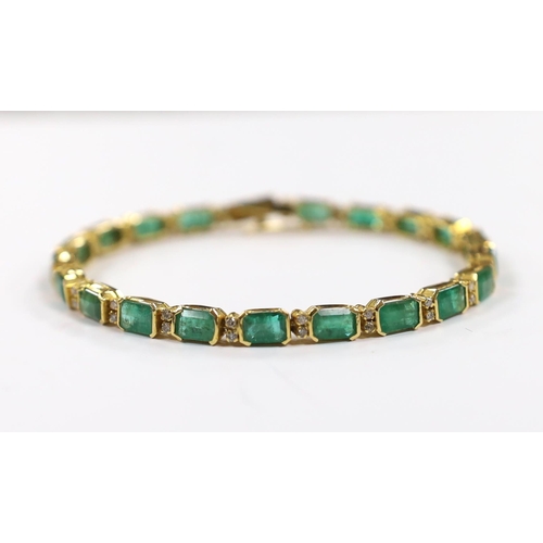 917 - A modern 18k yellow metal and twenty stone emerald set line bracelet, with diamond chip spacers, 18c... 