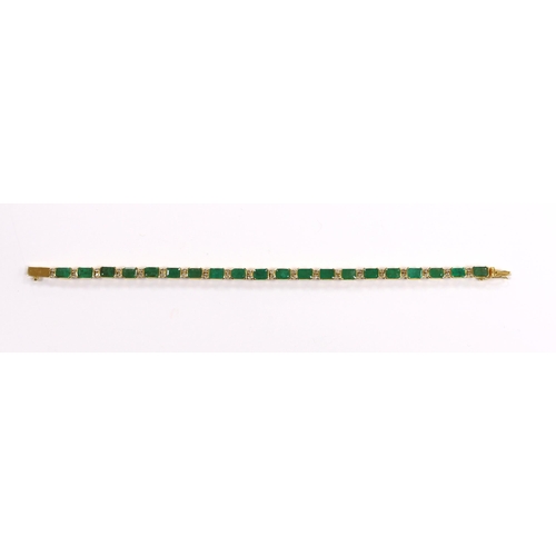 917 - A modern 18k yellow metal and twenty stone emerald set line bracelet, with diamond chip spacers, 18c... 