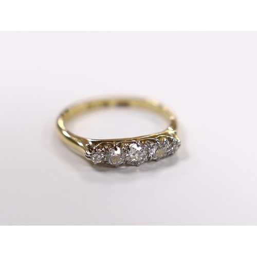 922 - A 1920's 18ct, plat and graduated five stone diamond set half hoop ring, size K/L, gross weight 2.6 ... 