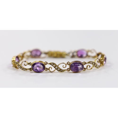 932 - An early 20th century 9ct, amethyst and seed pearl cluster set bracelet, with carved barrel shaped c... 