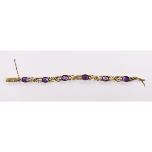 932 - An early 20th century 9ct, amethyst and seed pearl cluster set bracelet, with carved barrel shaped c... 