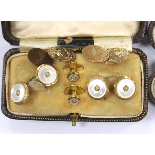 934 - A pair of 9ct gold oval cufflinks, each engraved with a yacht, 5.8 grams, together with two yellow m... 