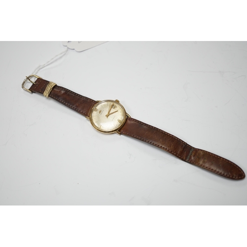 958 - A gentleman's 9ct gold Marvin automatic wrist watch, with date aperture, on a leather  strap.