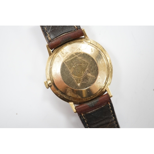 958 - A gentleman's 9ct gold Marvin automatic wrist watch, with date aperture, on a leather  strap.