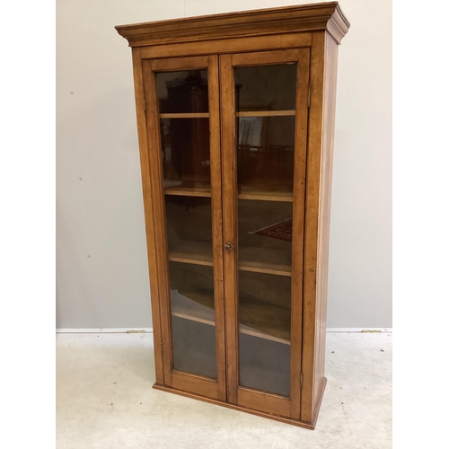 1002 - An early 20th century oak and mahogany narrow bookcase with later plinth foot, width 78cm, depth 36c... 