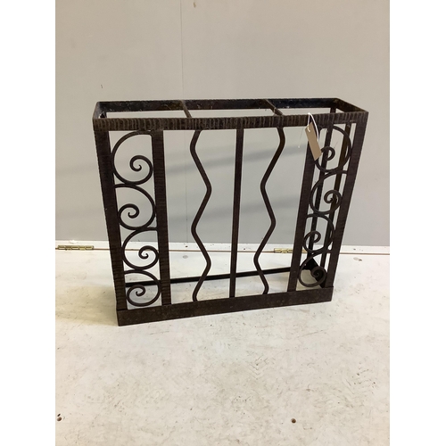 1022 - A French wrought iron three division stick stand, width 55cm, depth 15cm, height 50cm