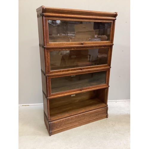 1057 - A Globe Wernicke oak four section bookcase, width 86cm, depth 27cm, height 140cm (one door detached)... 