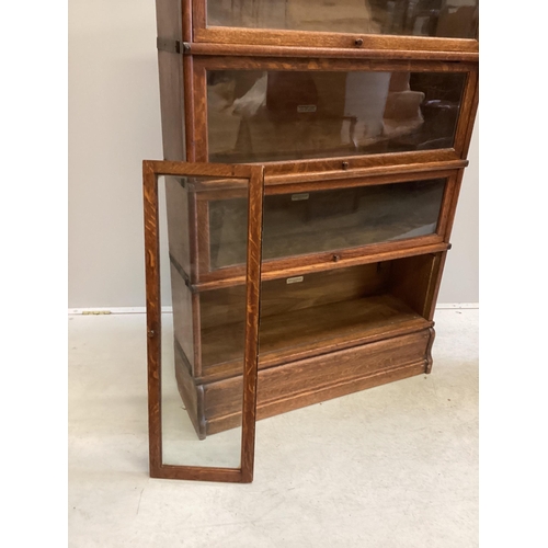 1057 - A Globe Wernicke oak four section bookcase, width 86cm, depth 27cm, height 140cm (one door detached)... 