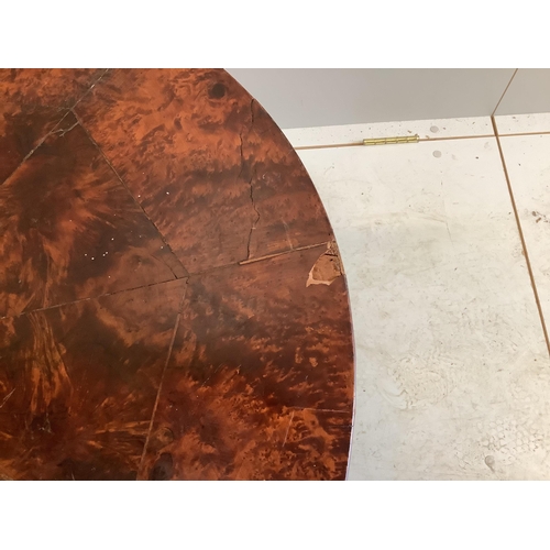 1060 - A circular amboyna coffee table, diameter 91cm, height 40cm