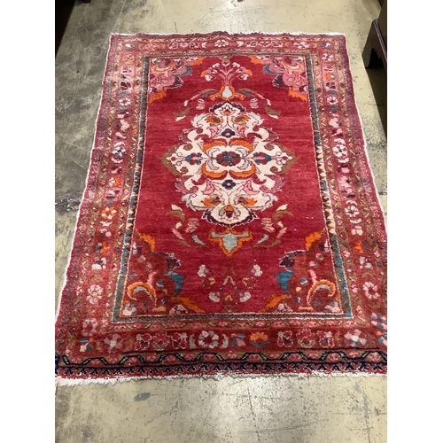 1061 - A Turkish red ground rug, 150 x 106cm