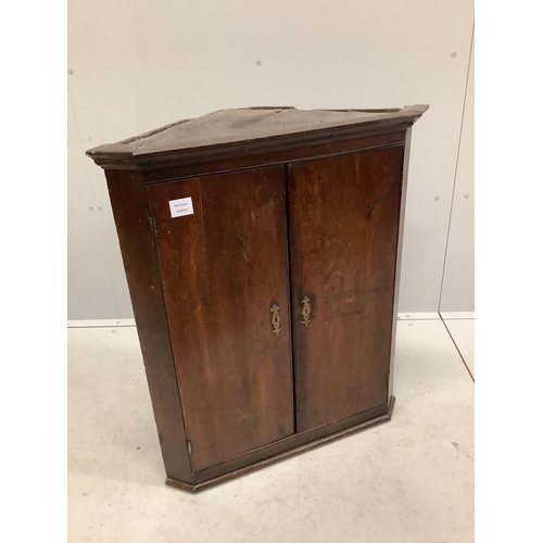 1069 - A George III oak hanging corner cupboard, width 70cm, depth 41cm, height 82cm