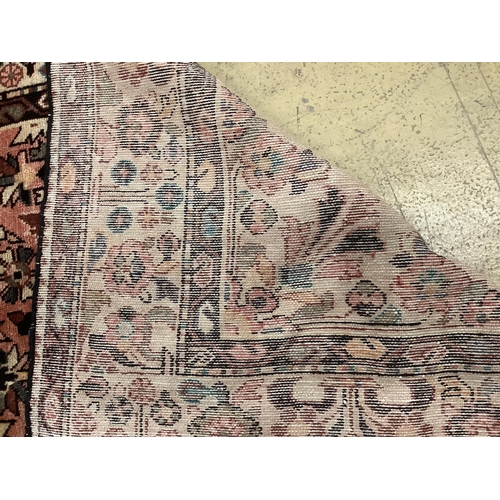 1070 - A Hussein Abad brick red ground carpet, 322 x 202cm