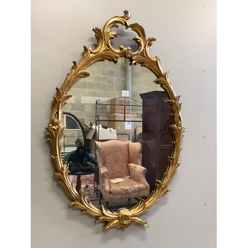 1123 - A reproduction giltwood and composition oval wall mirror, width 80cm, height 116cm