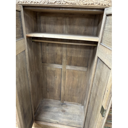 1149 - A late Victorian carved bleached oak wardrobe, width 103cm, depth 53cm, height 191cm