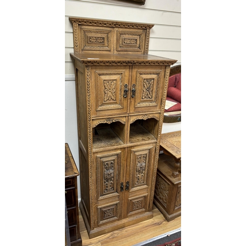 1152 - A late Victorian carved oak side cabinet, altered, width 68cm, depth 41cm, height 174cm