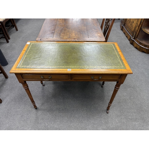 1184 - A Victorian satin walnut two drawer writing table, width 106cm, depth 53cm, height 75cm