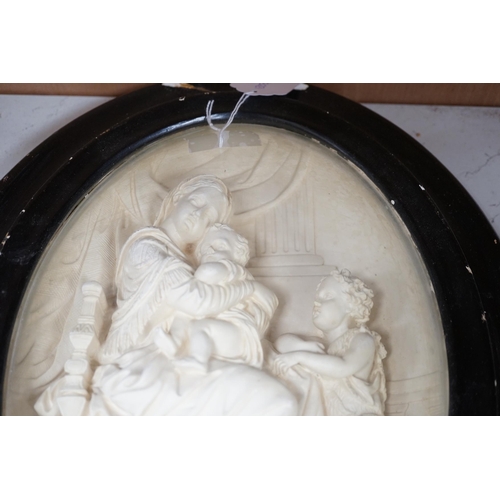 1288 - A pair of framed plaster ovals of the Madonna and Child with John the Baptist and the 'Descent from ... 